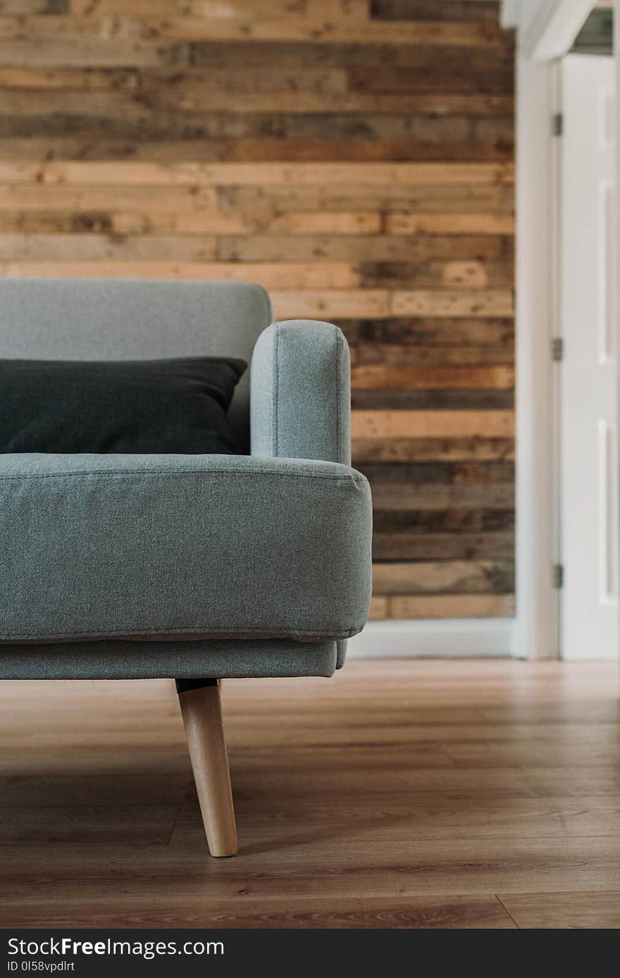 Gray Fabric Sofa Near White Wooden Wall