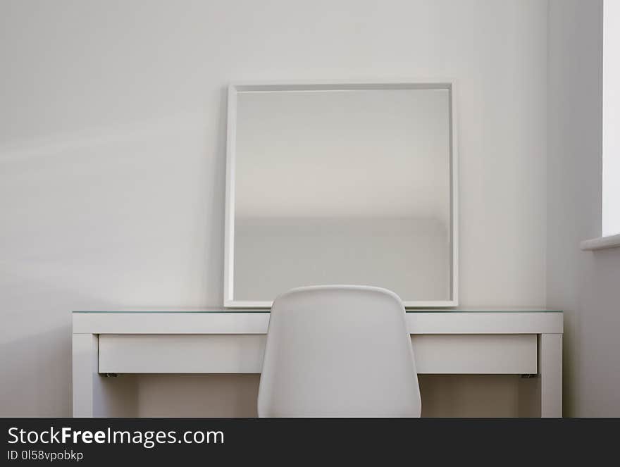 Chair in Front of Desk With Mirror on Top