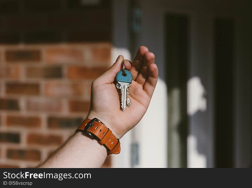 Person Holding Silver Keys