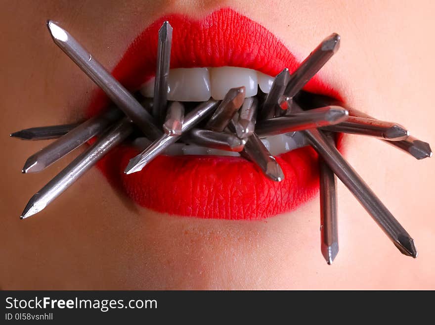 Woman Biting Gray Nails in Her Mouth