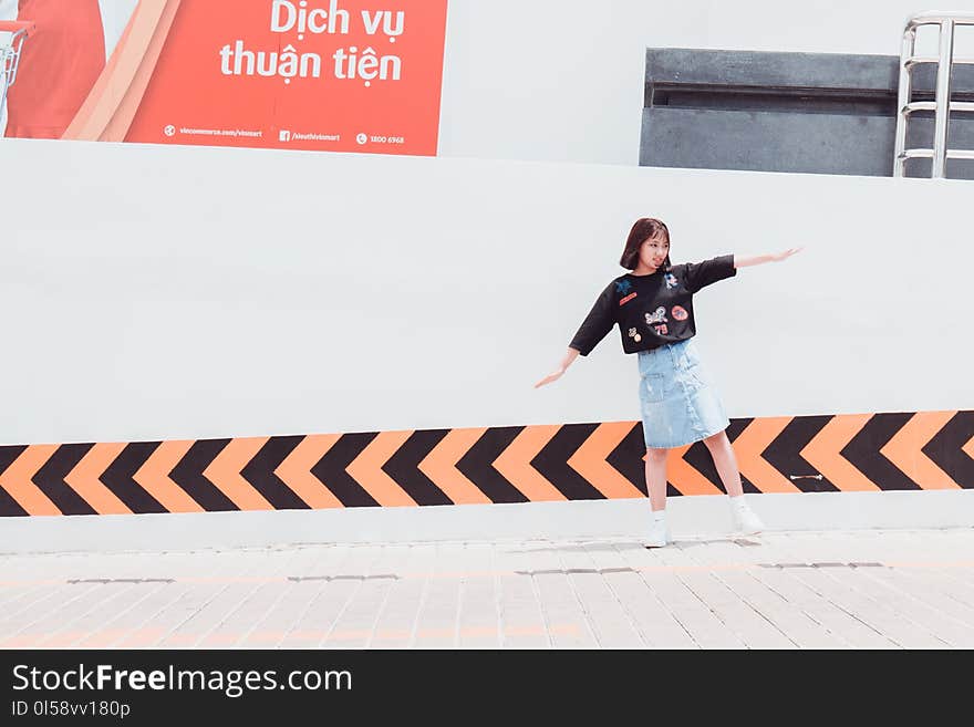 Woman in Black Shirt Standing Near Building