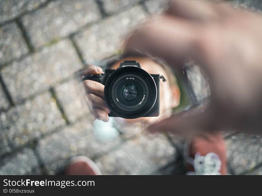 Selective Photo of Person Holds Black Dslr Camera