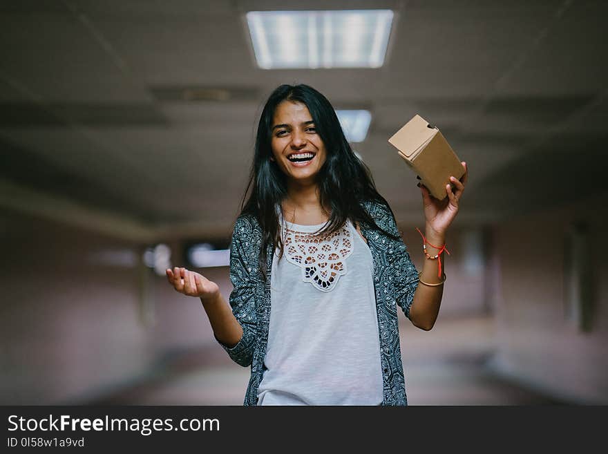 Woman Holding Brown Cardboard Box