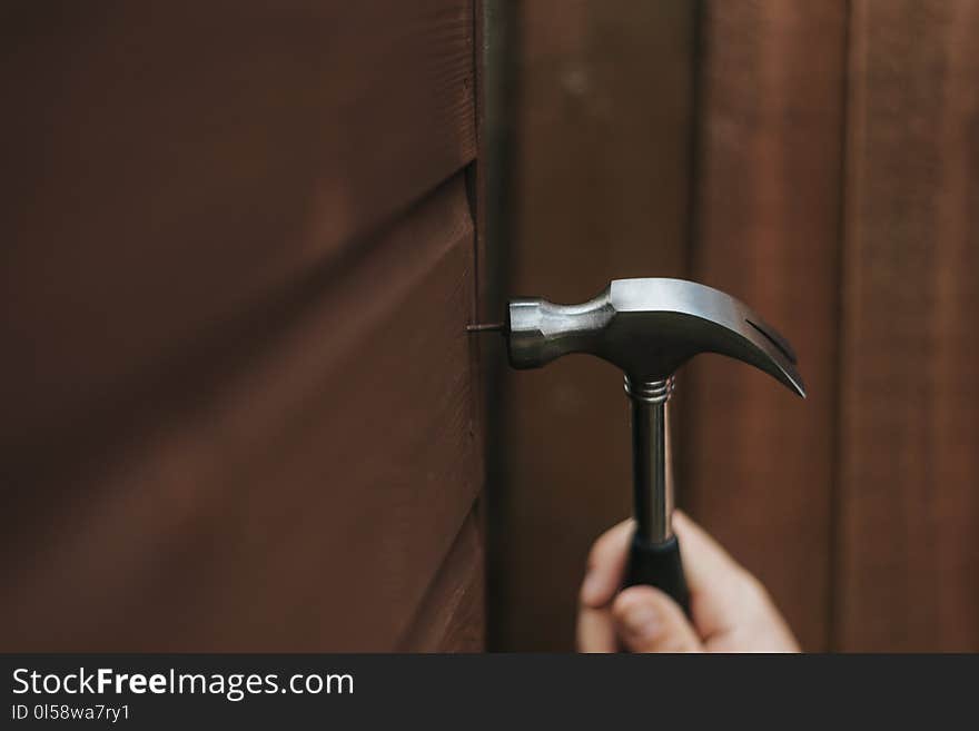 Person Holding Curved Claw Hammer