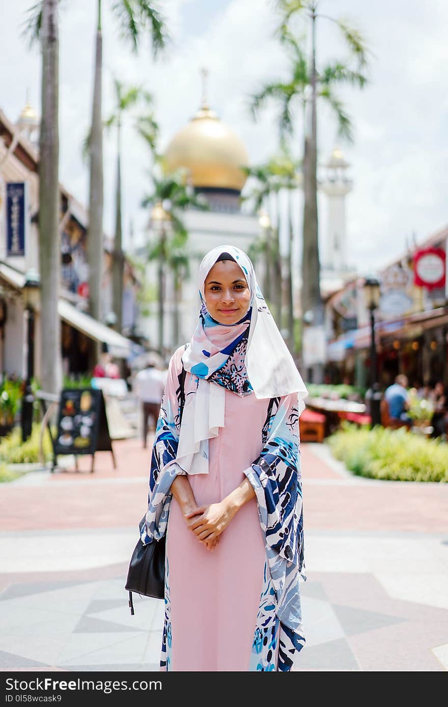 Woman Wearing Hijab and Abaya Dress While Standing With Mosque As Background