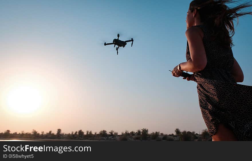 Woman Holding Remote of Drone