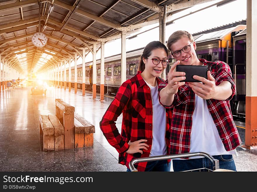 Man and Woman Taking Selfie Near Gray Train