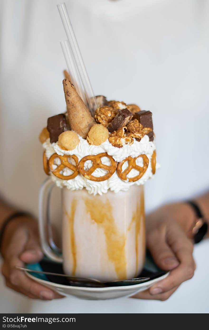 Person Holding Saucer With Mug of Chocolate Ice Cream Coffee