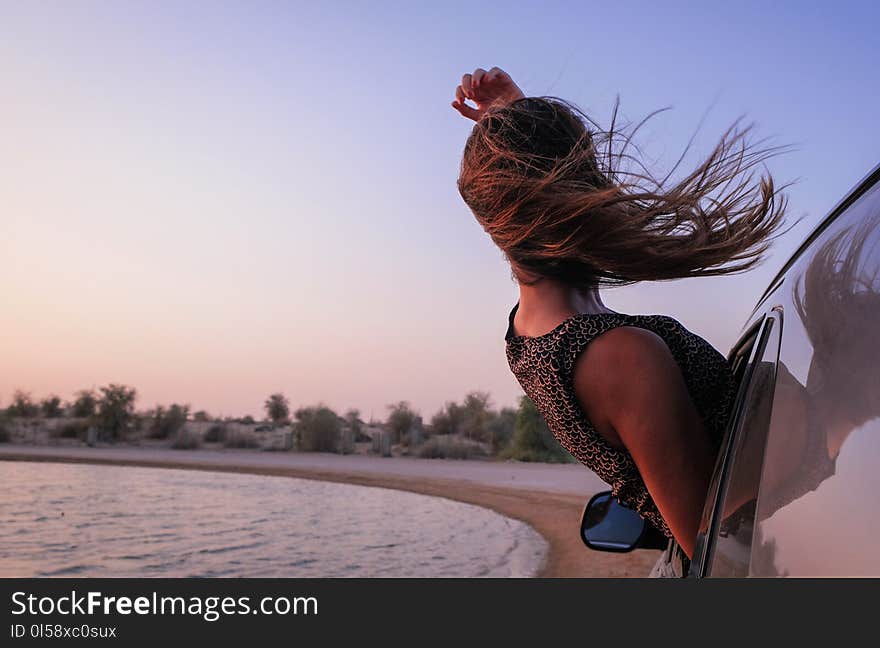 Woman With Brown Hair in Car during Sunset