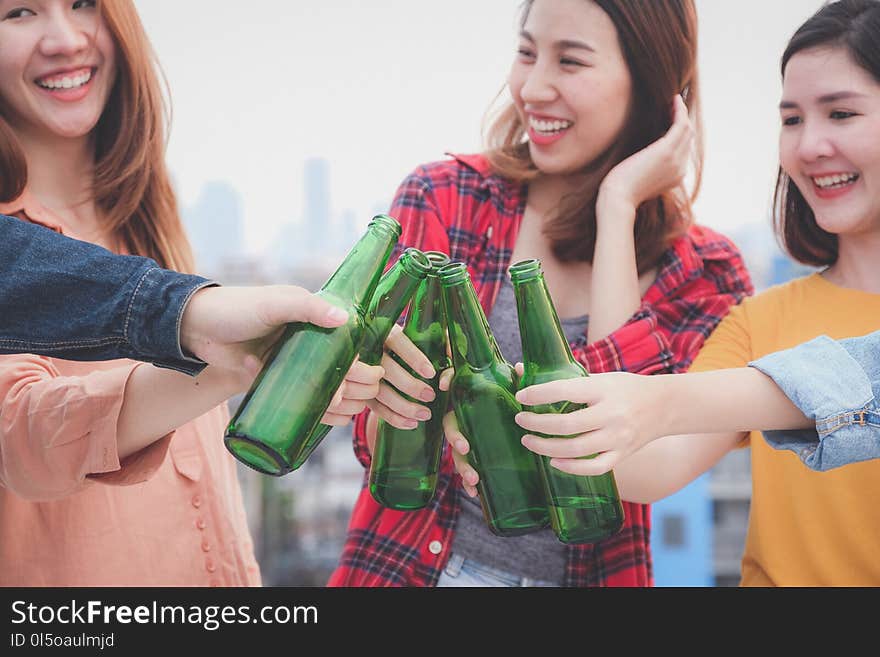 Group of asian women drinking at rooftop party, outdoors celebration