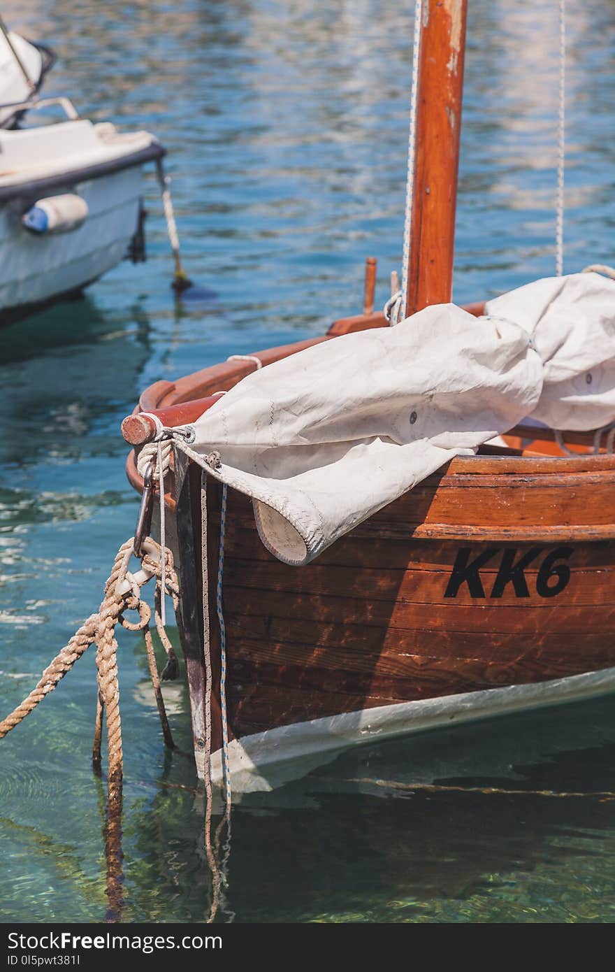 White Textile on Brown Boat