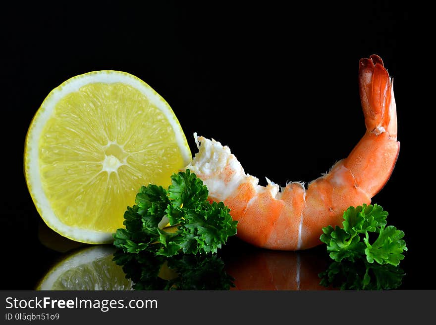 Fresh shrimp with slice of lemon on black background. Fresh shrimp with slice of lemon on black background.