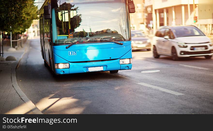 Bus Moving On The Road In City In Early Morning