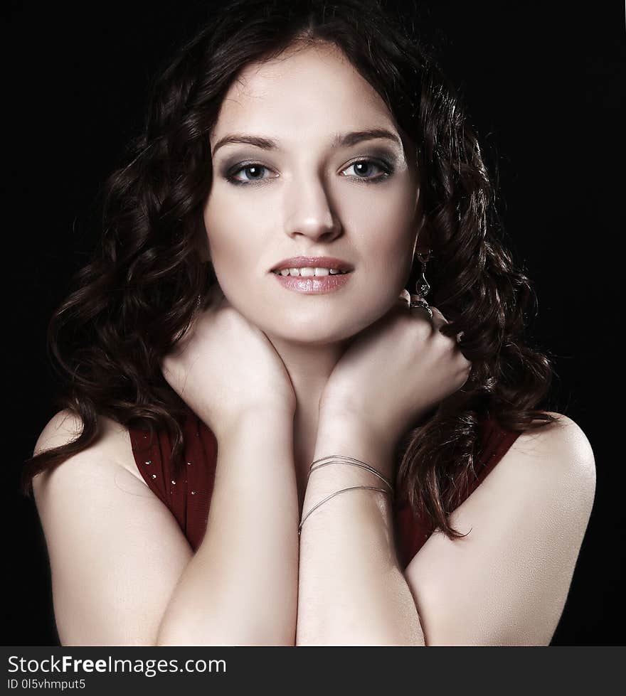 Portrait of beautiful woman in red dress posing for the camera