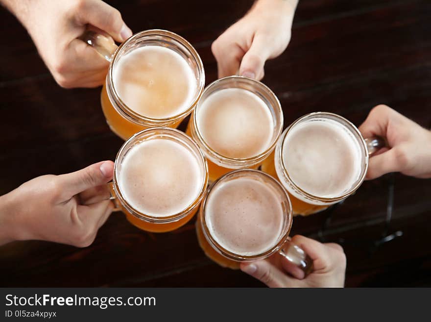 Friends clinking glasses with beer