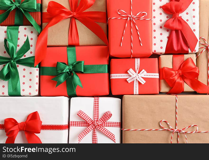 Beautifully wrapped gift boxes as background, closeup