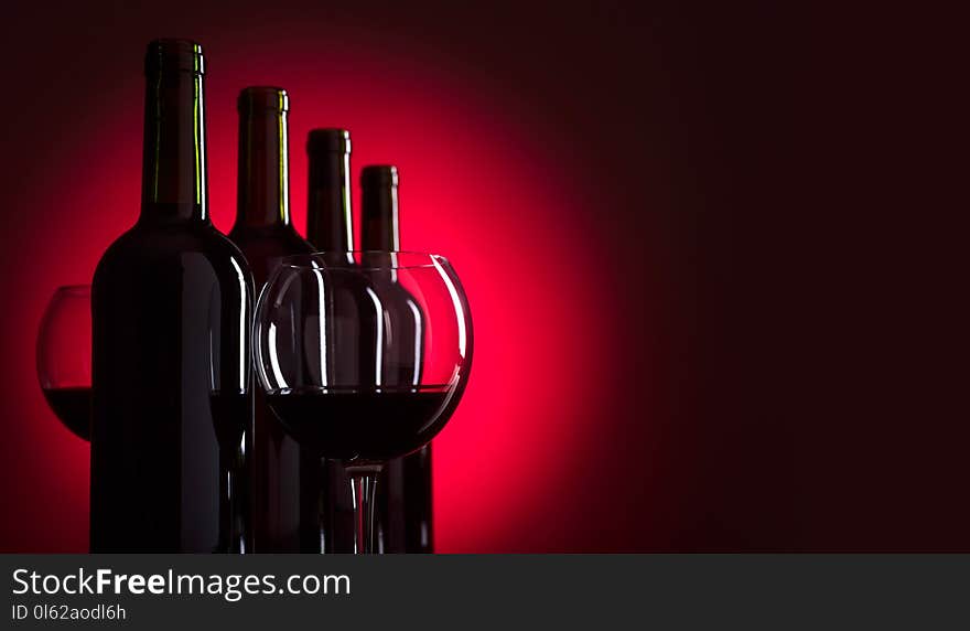 Glasses and bottles of red wine, copy space for your text. Glasses and bottles of red wine, copy space for your text.