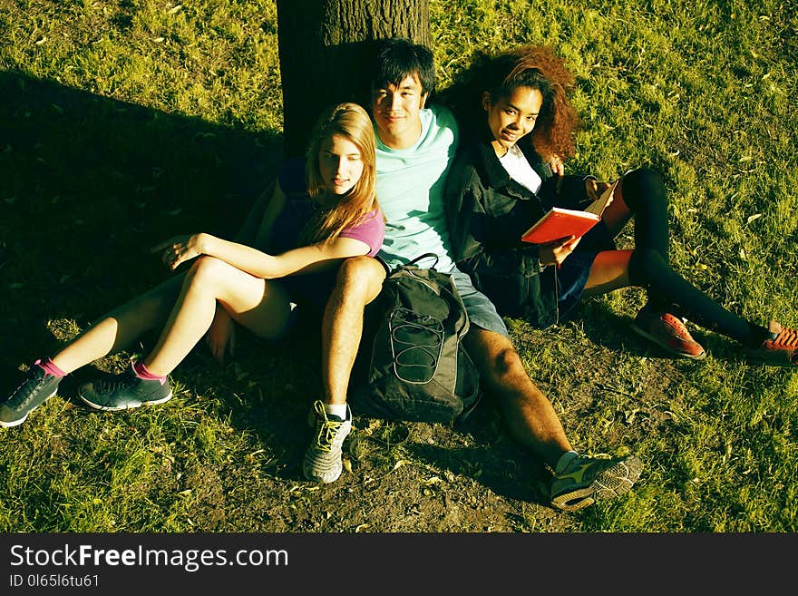 Cute group of teenages at the building of university with books huggings, diversity nations, having lunch