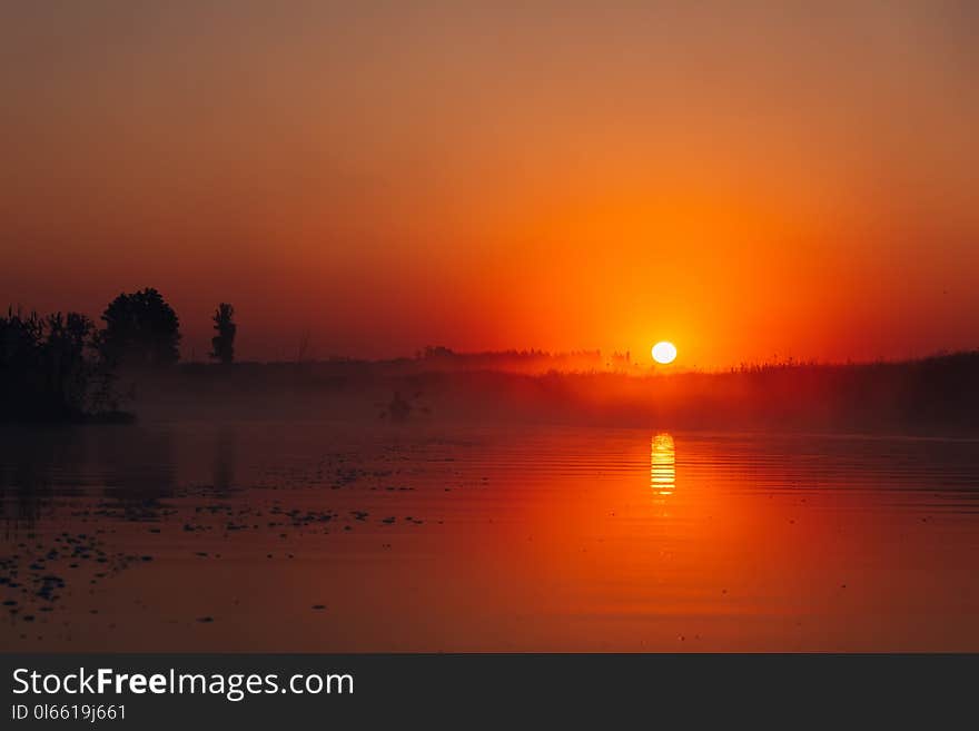 People kayaking down the river at sunrise