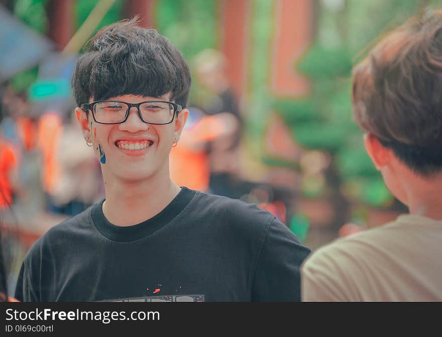 Smiling Man in Black Shirt Wearing Eyeglasses