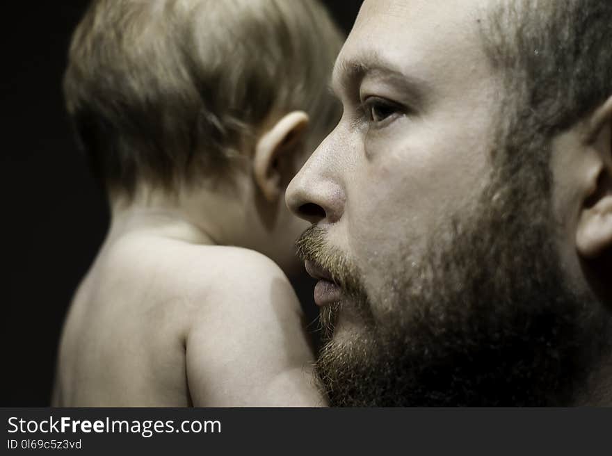 Photo of Man Carrying Baby