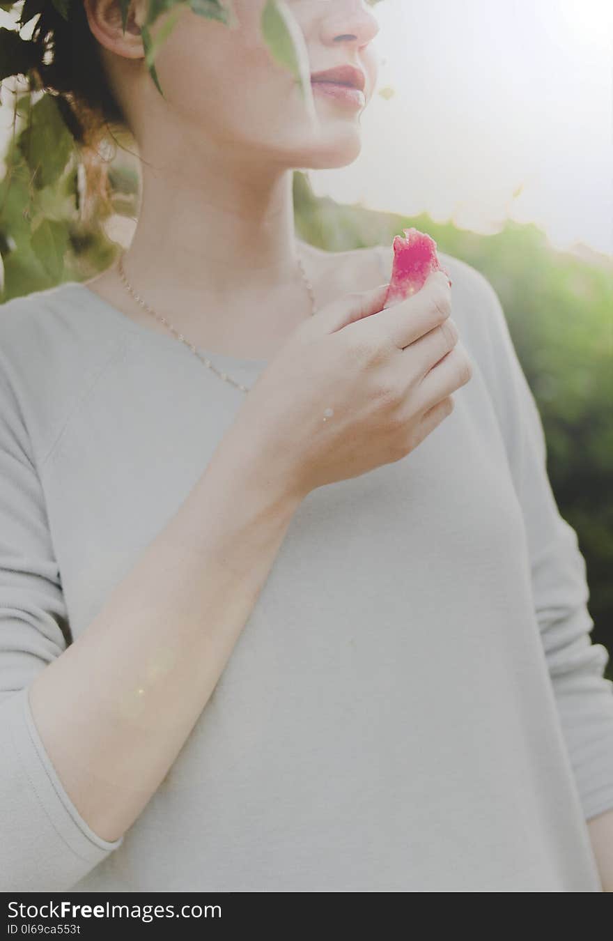 Woman Holding Sliced Fruit