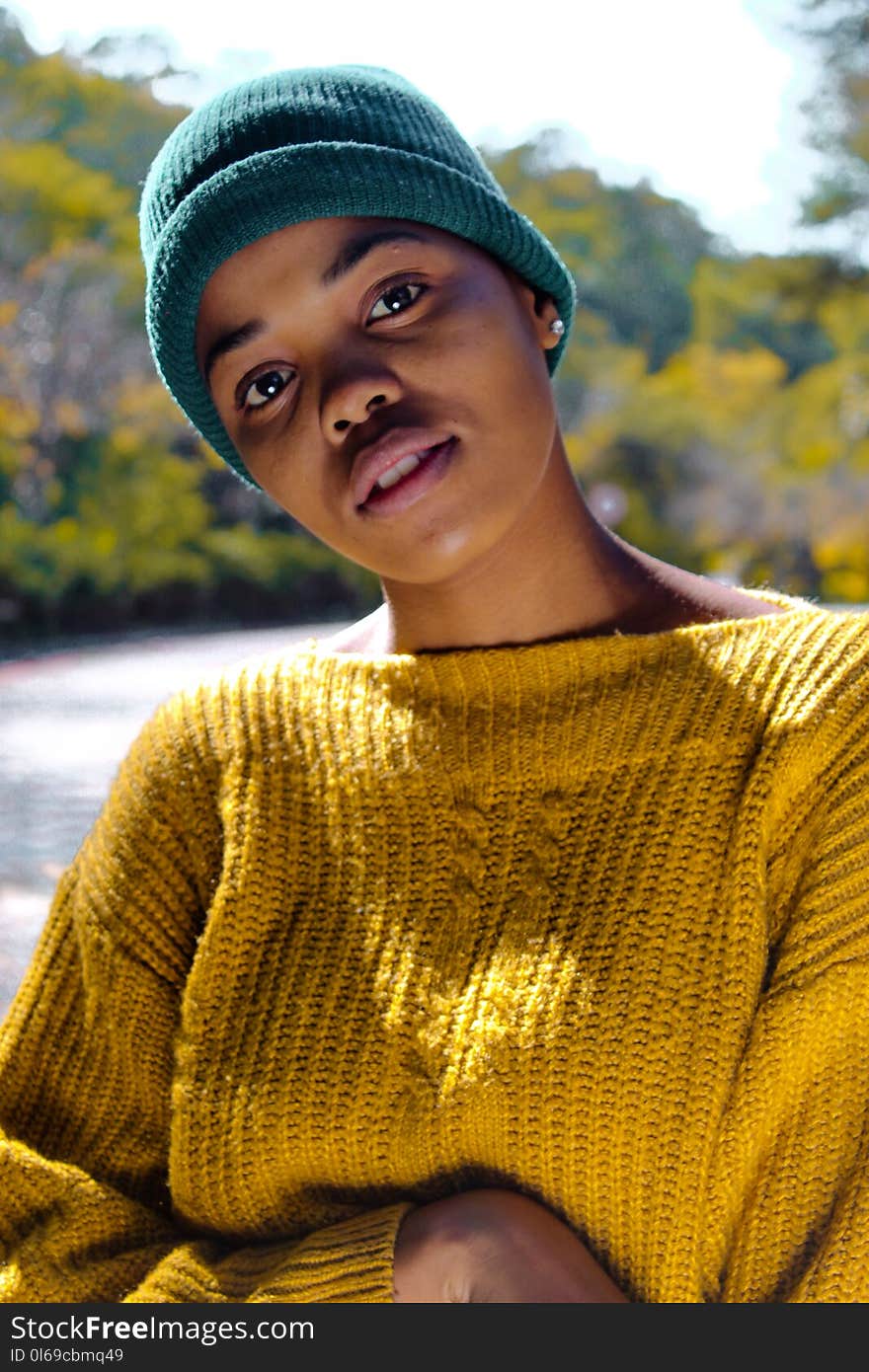 Woman Wearing Yellow Knit Sweater and Blue Knit Hat