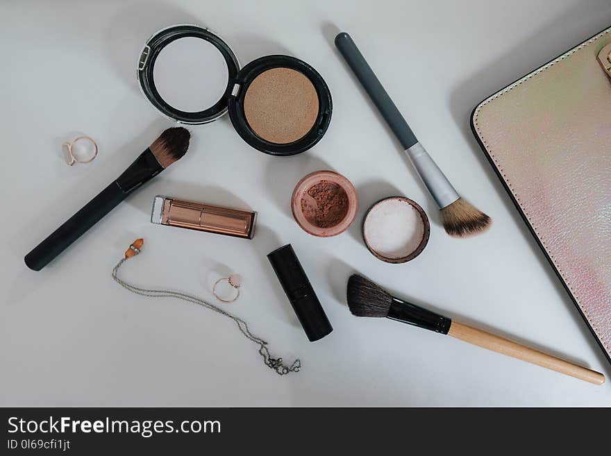 Flat Lay Photography of Makeup Brushes and Compacts