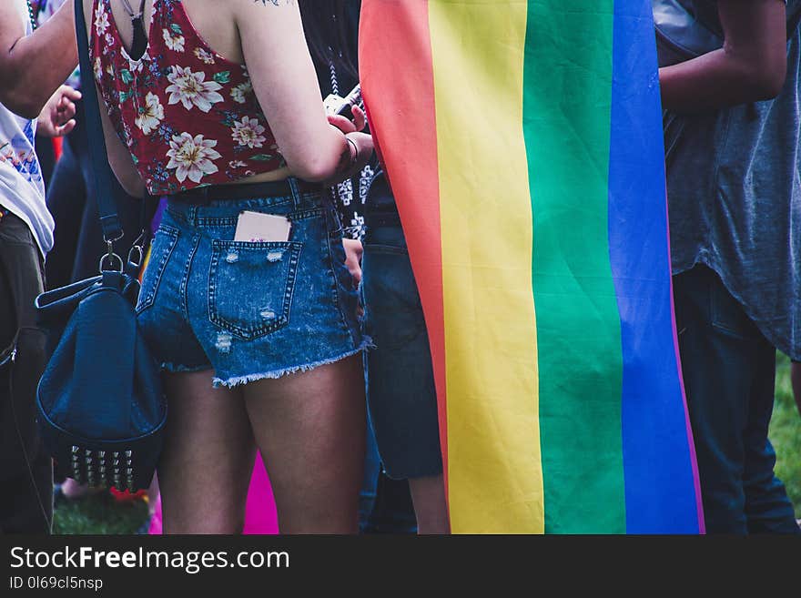 Closeup Photo of Person Wearing Blue Denim Short Shorts Near the Flag