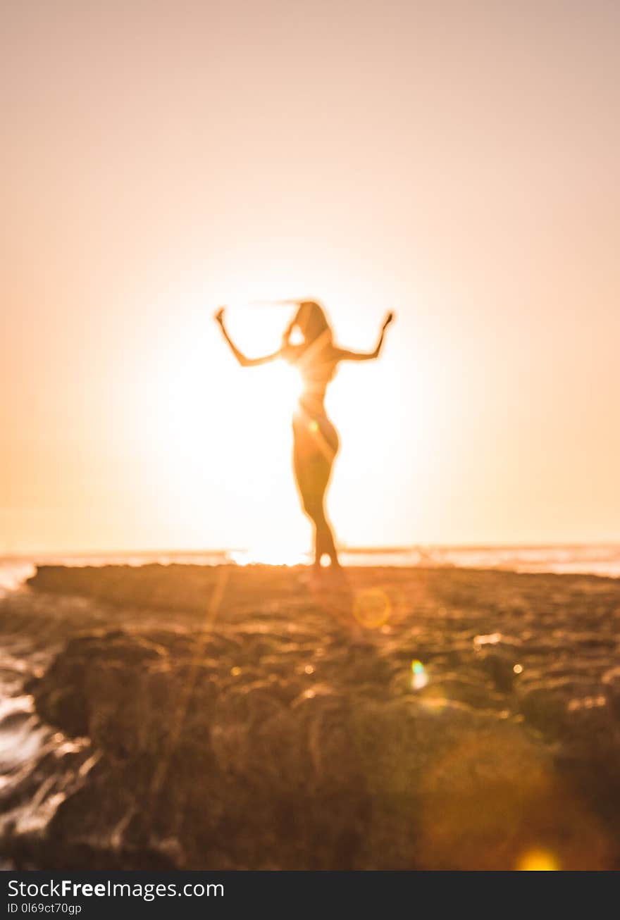 Silhouette of Woman Near Cliff