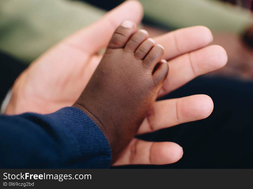 Baby&#x27;s Right Foot on Person&#x27; Left Palm