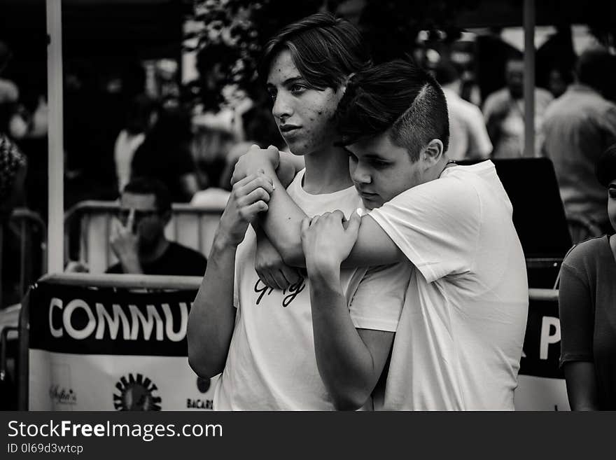 Grayscale Photography of Man Hugging Each Other