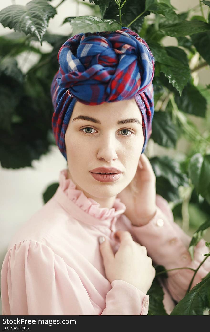 Woman in Pink Long-sleeved Top and Blue and Red Headdress