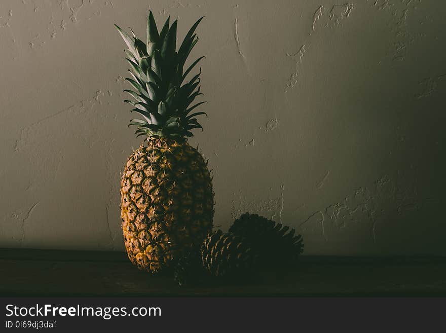 Pineapple Fruit Near Pine Cones