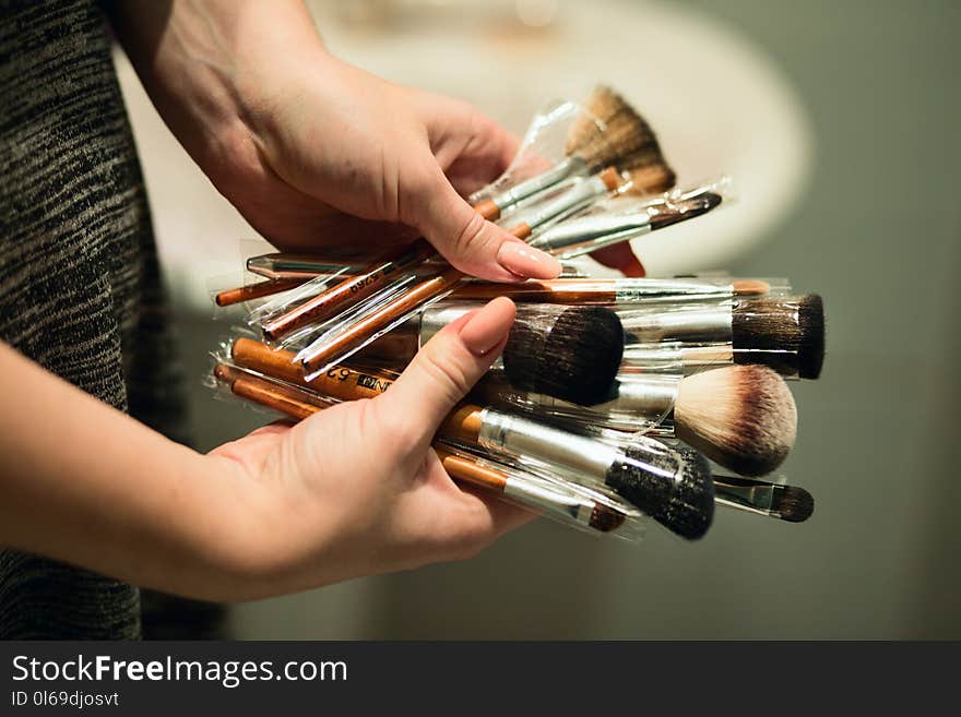 Person Holding Makeup Brushes