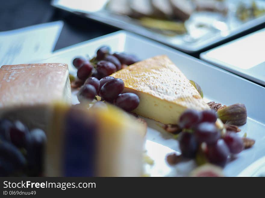 Shallow Focus Photography of Grapes and Sliced Cake