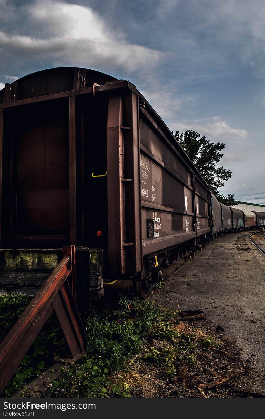 Brown and Black Train Under White Clouds