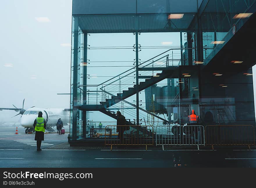 Photo of Glass Building Near Airplane