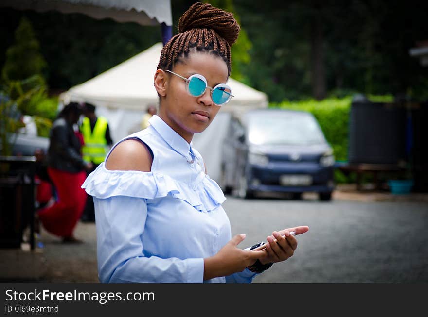 Selective Focus Photo of Woman Holding Android Smartphone