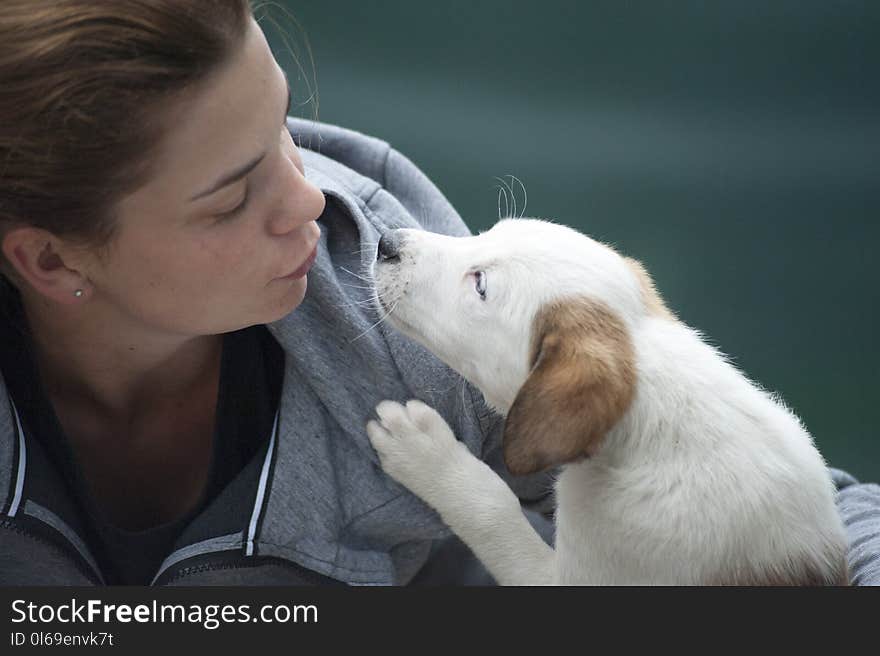 Woman Wearing Gray Jacket Beside White Puppy