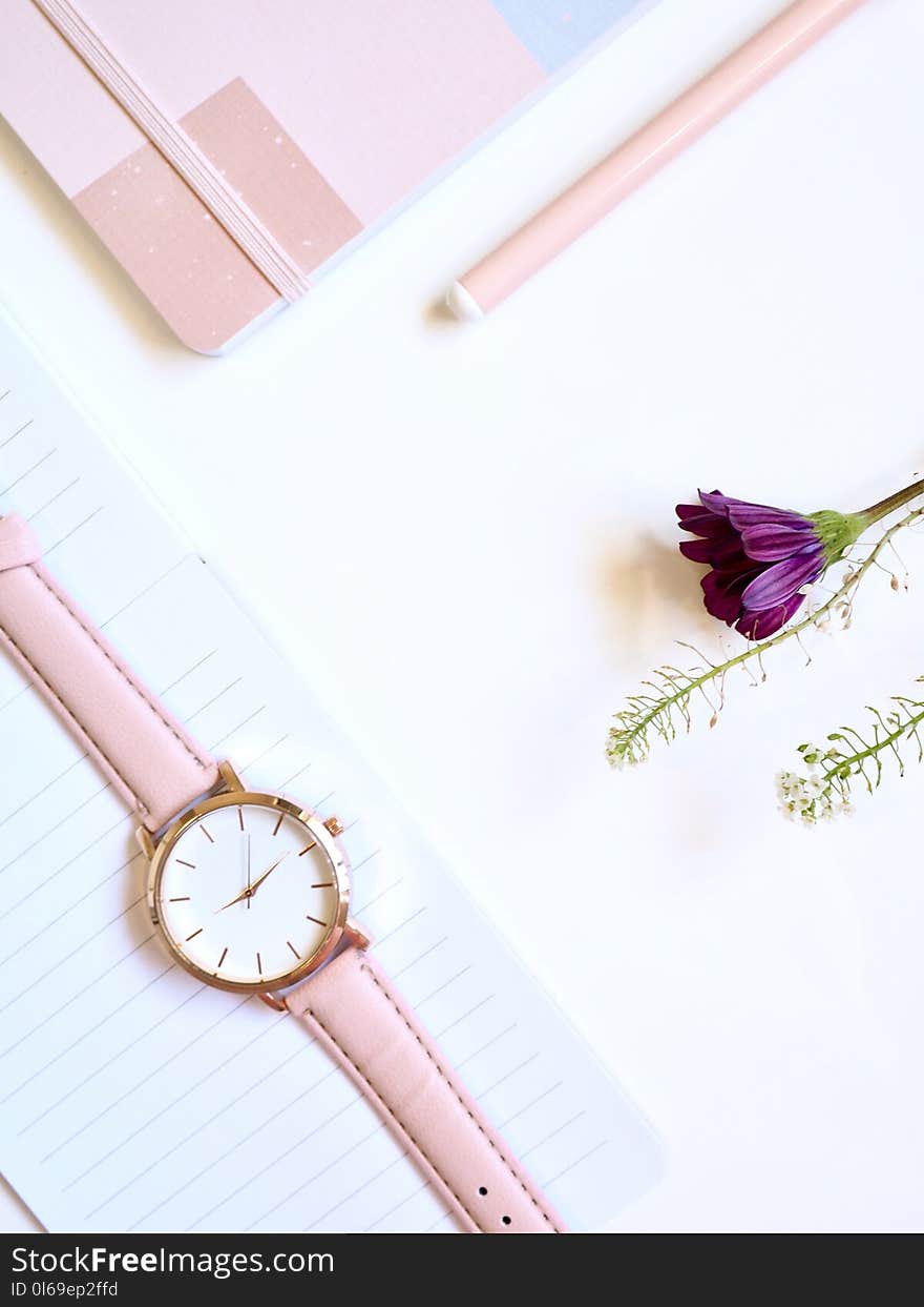 Round Gold-colored Analog Watch at 2:46 on Top of White Paper