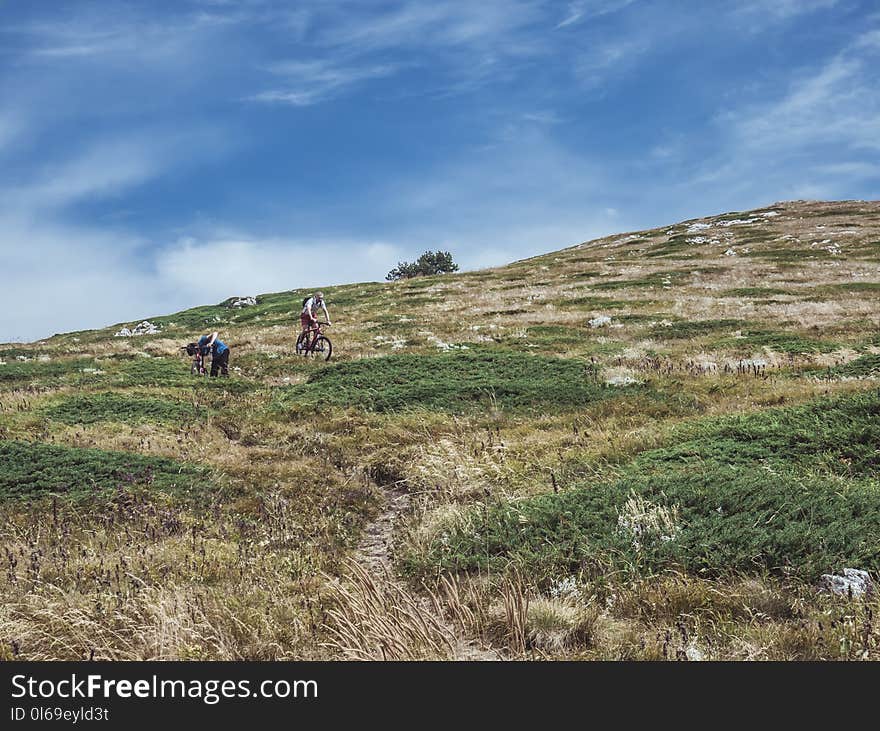 Man Cycling Down Hill