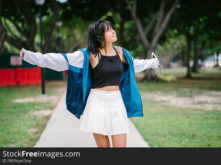 Woman Wearing Jacket, Crop Top and Mini Skirt