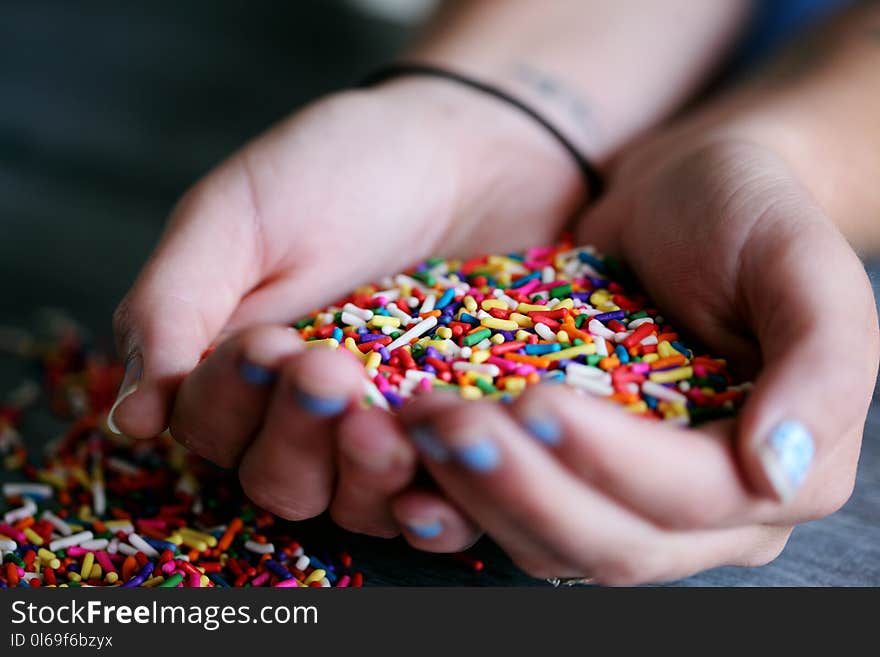 Person Holding Full of Sprinkles