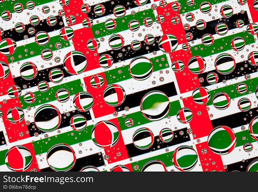 Flags of United Arab Emirates, behind a glass covered with rain drops.Pattern from flags of United Arab Emirates. Flags of United Arab Emirates, behind a glass covered with rain drops.Pattern from flags of United Arab Emirates