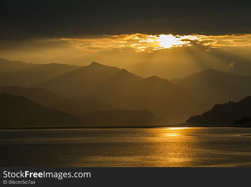 View on Fewa Lake and mountains during sunset in Pokhara, Nepal. View on Fewa Lake and mountains during sunset in Pokhara, Nepal