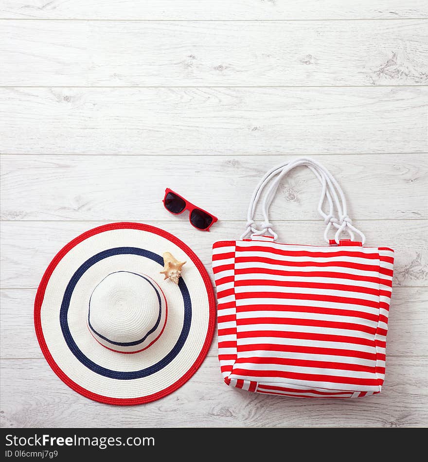 Summer Accessories Hat And Bag On White Wooden Background.