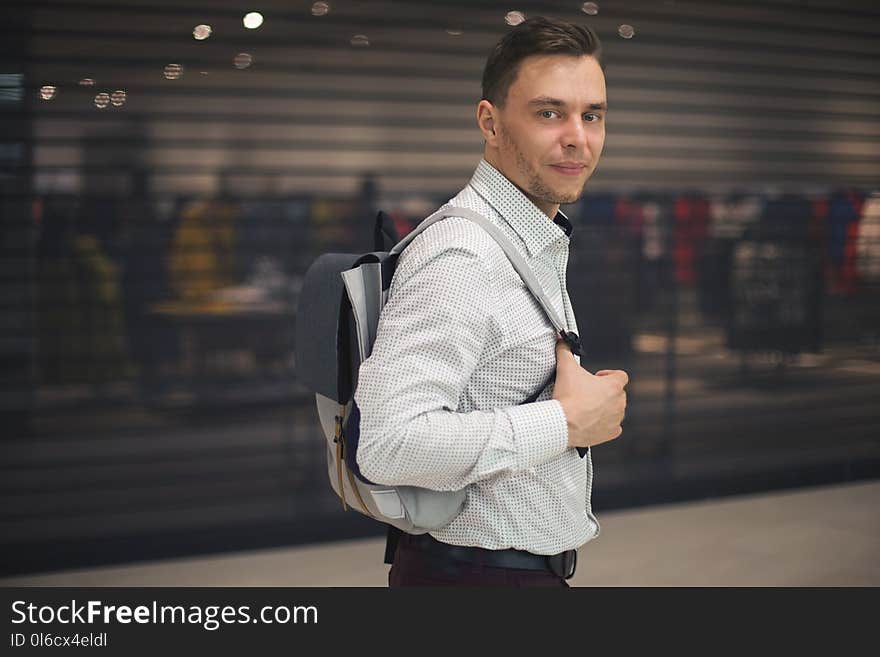 Portrait Of Handsome Man Fashion Hairstyle Holds Bag. Adult in Mall Chain Store