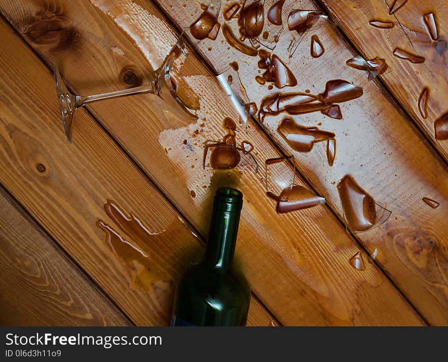 Broken Wine Glass With Bottle On Table