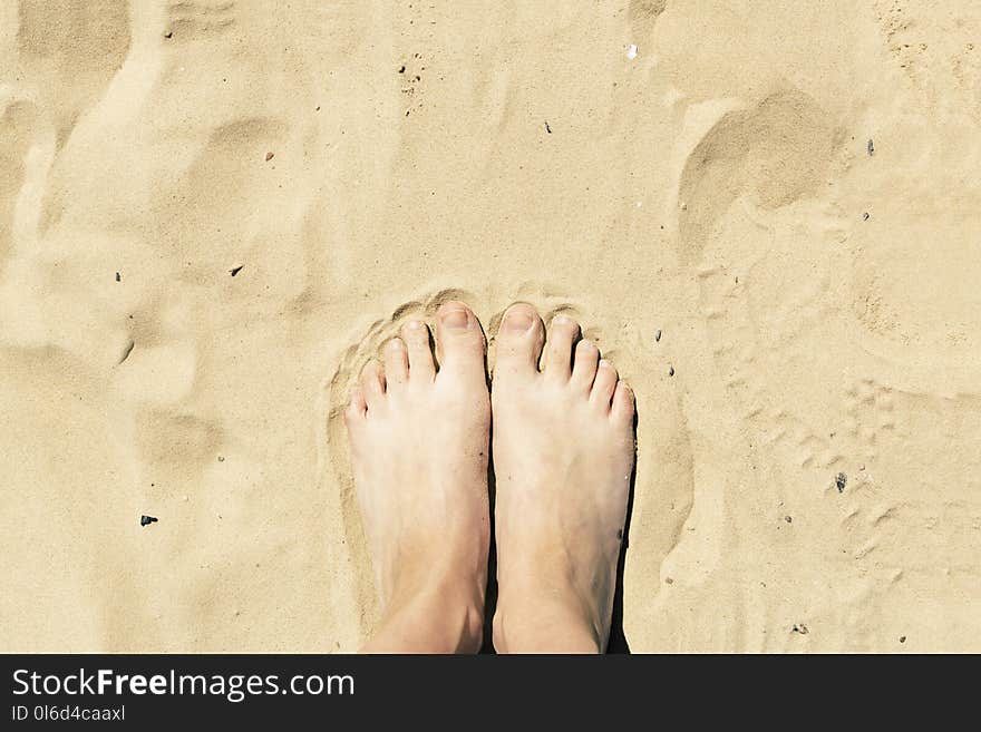 Feet in the sand. Summer vacation concept. Yellow beach sand